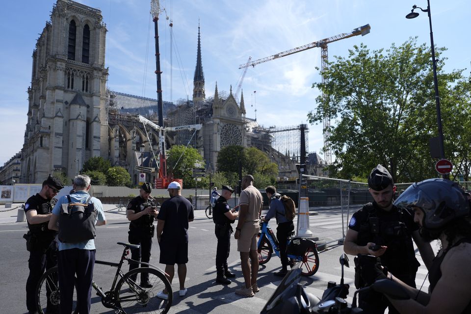 Police check people at the security perimeter outside Notre Dame cathedral (David Goldman/AP)