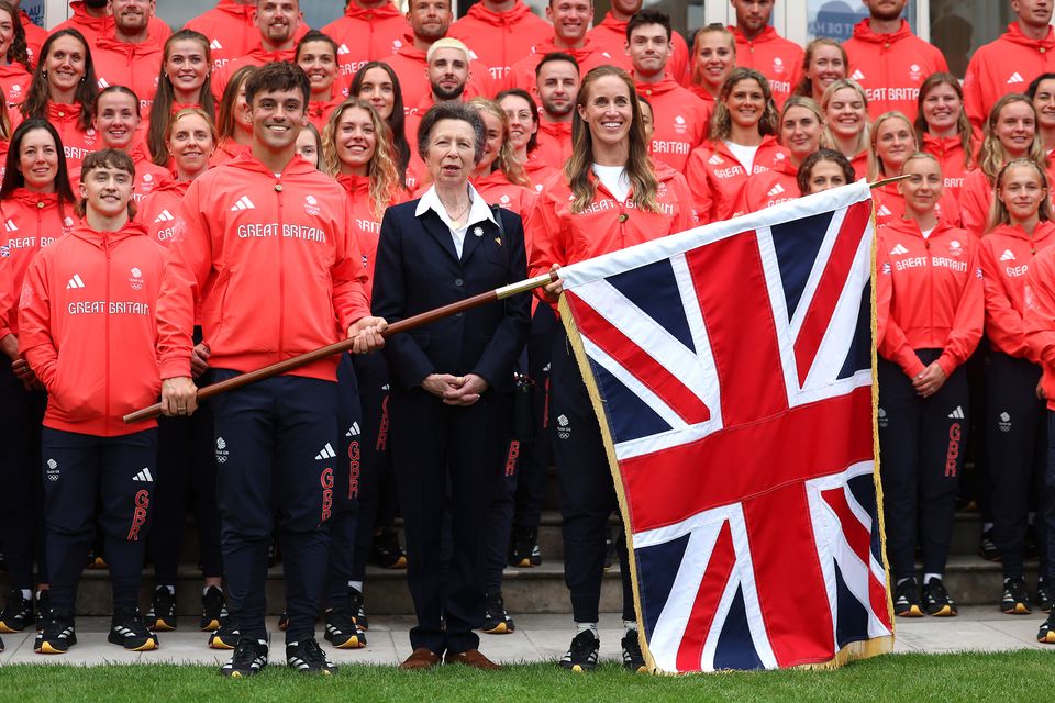 Anne stands between Team GB Flagbearers Helen Glover and Tom Daley, and other team members ahead of the Paris 2024 Olympics (Richard Pelham/PA)