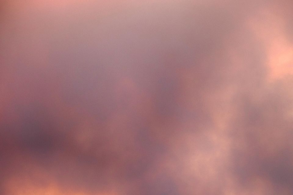 A surfer takes off on a wave in Santa Monica during sunset under a blackened sky from the Palisades fire in the Pacific Palisades (Richard Vogel/AP)