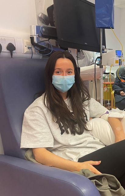 Abbie in hospital wearing a mask.