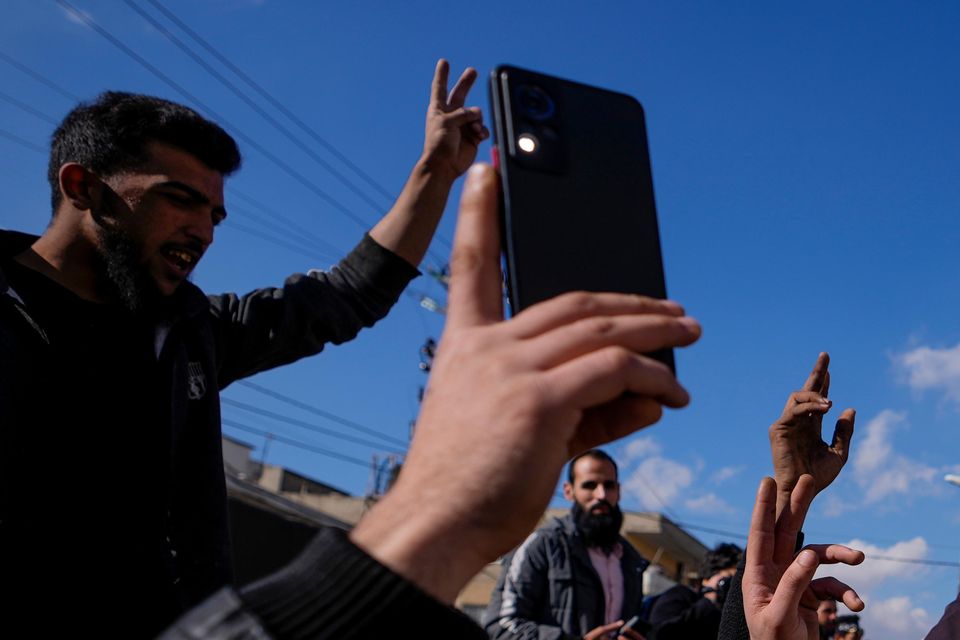 Syrians celebrate the fall of Syrian President Bashar Assad’s government in the town of Bar Elias, Lebanon, near the border with Syria (Hassan Ammar/AP)