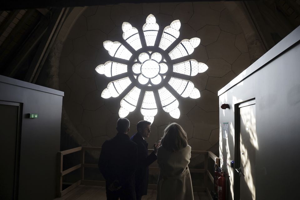 The Macrons were taken high into the cathedral roof to see the detail of the repairs (Christophe Petit Tesson, pool via AP)