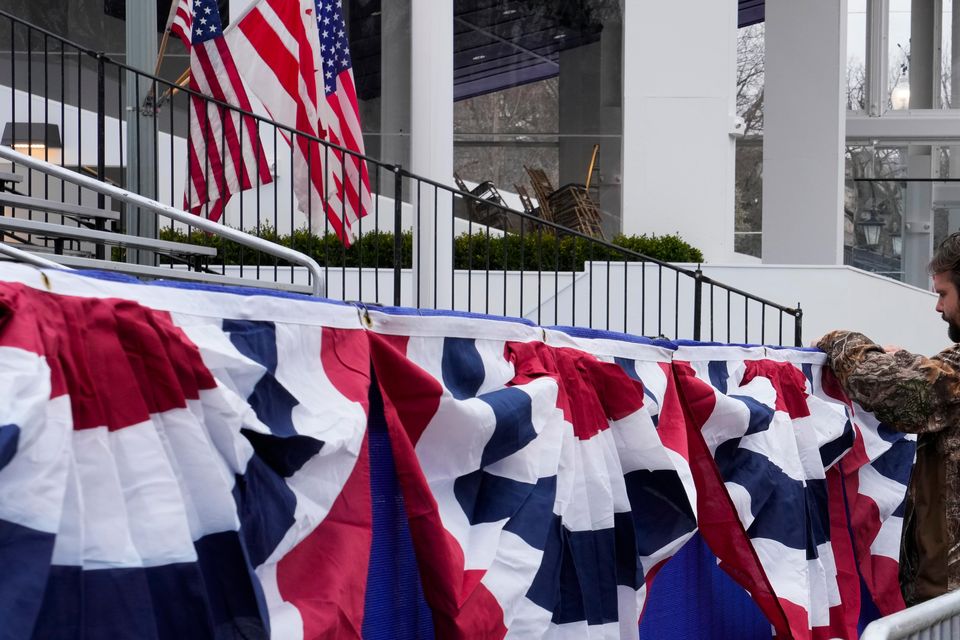 Work continues near the presidential reviewing stand on Pennsylvania Avenue outside the White House (Jon Elswick/AP)