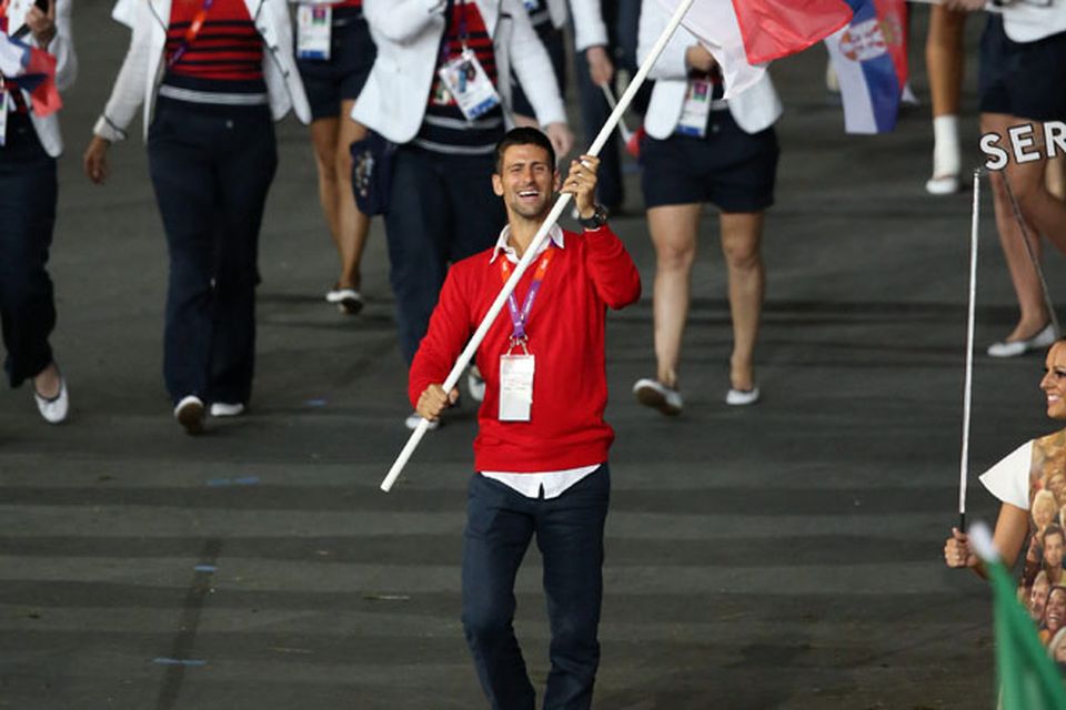 Serbia's Novak Djokovic holds his counties flag at the Opening Ceremony at the Olympic Stadium, London. PRESS ASSOCIATION Photo. Picture date: Friday July 27, 2012. See PA story OLYMPICS Ceremony . Photo credit should read: Mike Egerton/PA Wire. EDITORIAL USE ONLY
