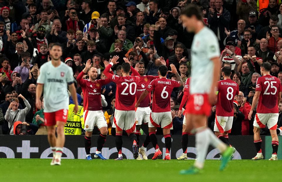 Manchester United’s players celebrate with Christian Eriksen, second left, after he opened the scoring (Martin Rickett/PA)