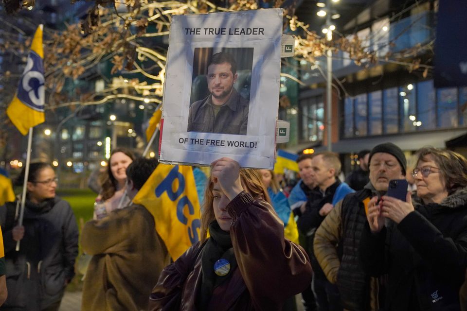 People held up banners supporting Ukraine (Jonathan Brady/PA)