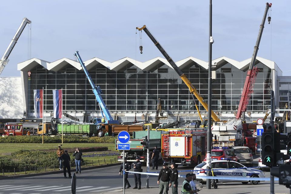 People and rescuers gather at the scene (AP)