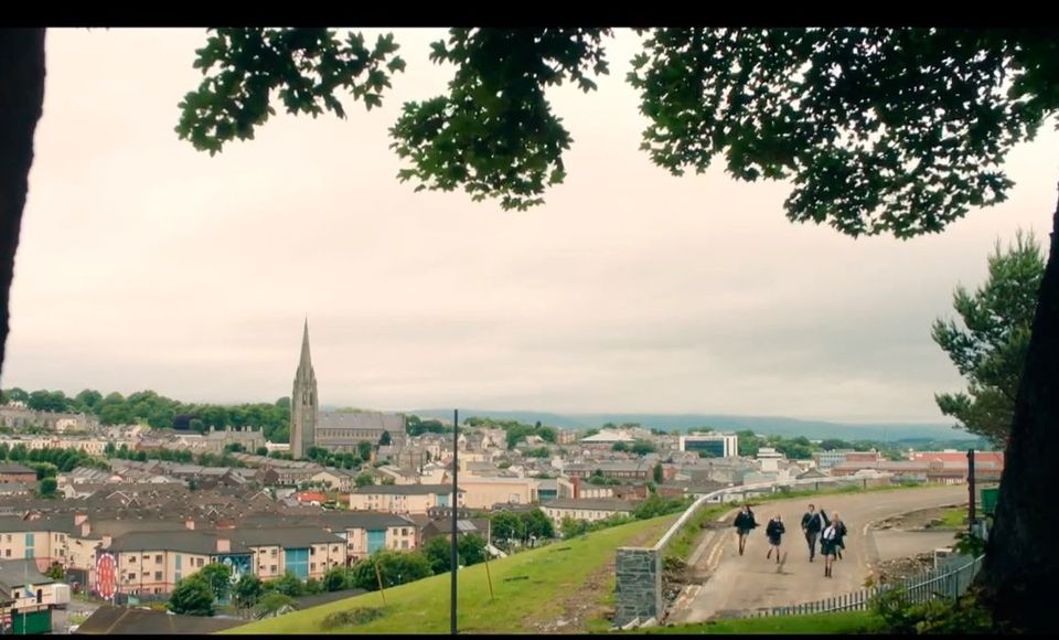 The Derry Girls chase Toto the dog down Orchard Row.