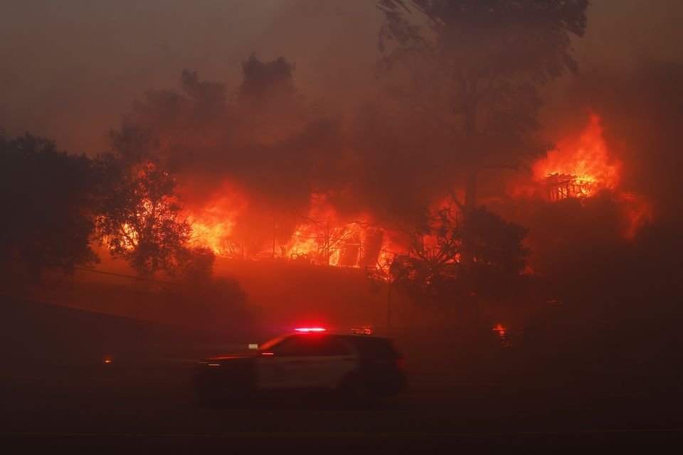 The Palisades Fire burns a property in the Pacific Palisades neighbourhood of Los Angeles (Etienne Laurent/AP)