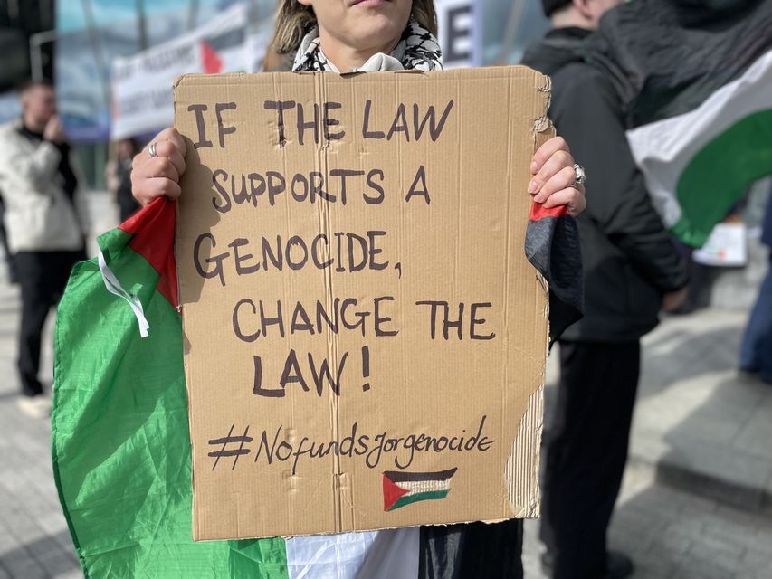 A member of the public holds a sign during a pro-Palestine protest outside the Central Bank in Dublin (PA)