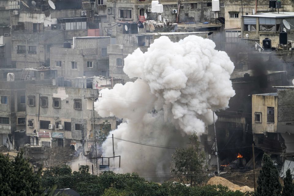 Israeli soldiers detonate an explosive device during a military raid in the West Bank refugee camp of Nur Shams, Tulkarem (Majdi Mohammed/AP)