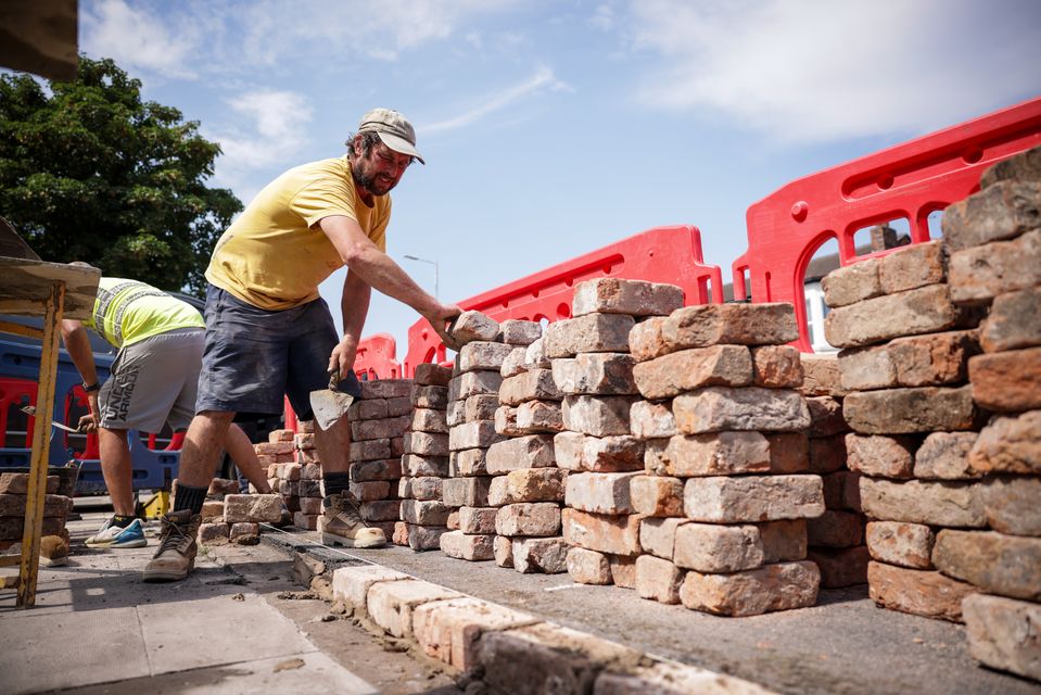 Kingswood Homes workers rebuild a wall outside the Southport Islamic Centre Mosque (James Speakman/PA)