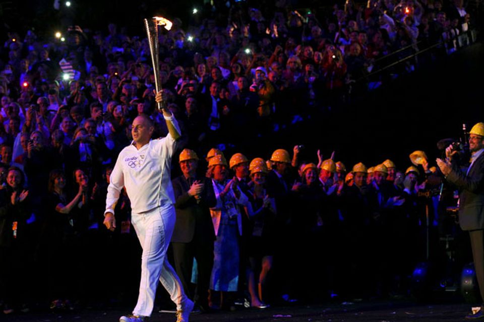 Steve Redgrave carries the Olympic flame into the stadium during the Opening Ceremony at  the 2012 Summer Olympics, Saturday, July 28, 2012, in London. (AP Photo/Cameron Spencer, Pool)
