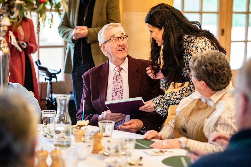 Eoin Down, 83, receives a gift to celebrate his birthday on Wednesday while attending the Winter Warmers gathering (Ben Birchall/PA