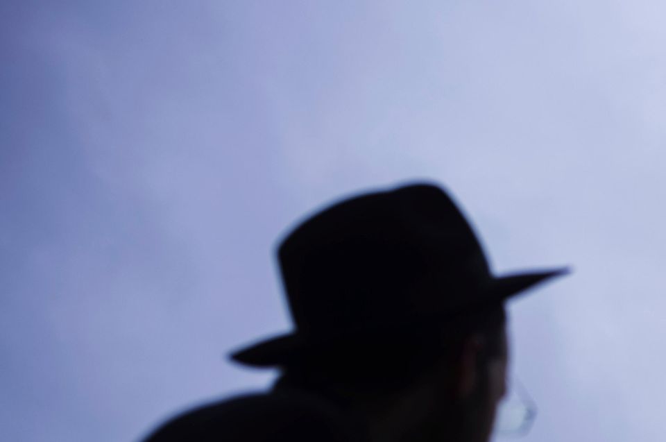 Rabbi Yehuda Teichtal, right, and Rabbi Shmuel Segal, left, watch the set-up of a giant Hanukkah Menorah by the Jewish Chabad Educational Centre in front of the Brandenburg Gate in Berlin (AP Photo/Markus Schreiber)