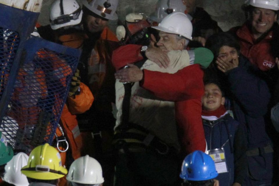 Chile's President Sebastian Pinera embraces miner Florencio Avalos after he was rescued from the collapsed San Jose gold and copper mine where he was trapped with 32 other miners for over two months near Copiapo, Chile.(AP Photo/Roberto Candia)