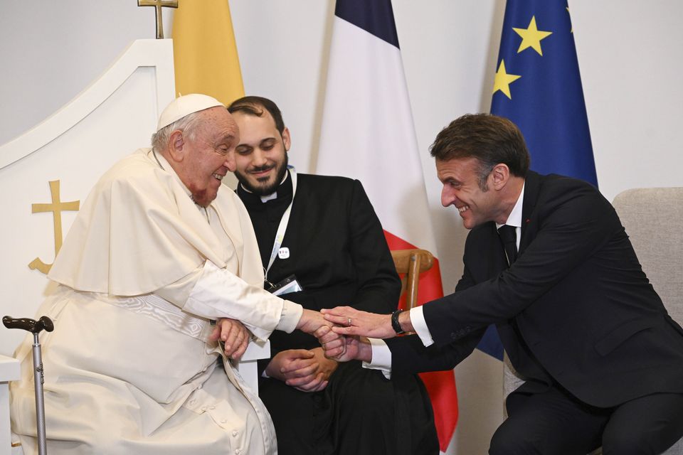 Pope Francis shakes hands with French President Emmanuel Macron in Ajaccio (Tiziana Fabi, Pool Via AP)