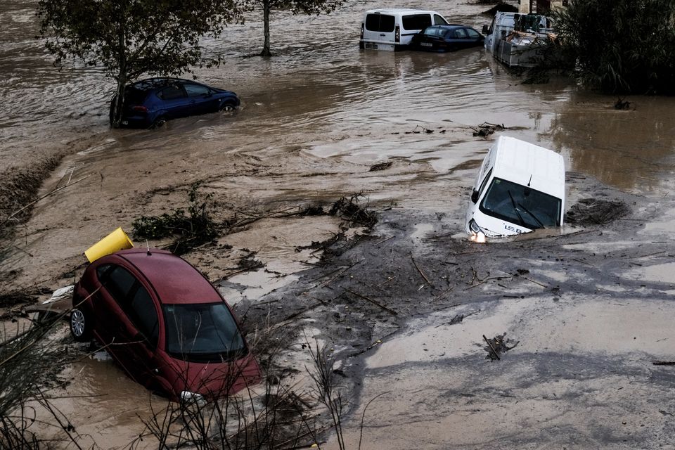 Cars being swept away in the town of Alora, Malaga (Gregorio Marrero/AP)