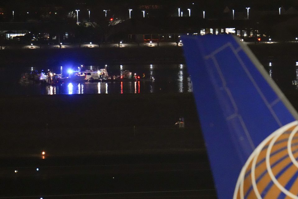 Boats work the scene on the Potomac River near Ronald Reagan Washington National Airport (Julio Cortez/AP)