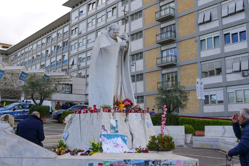 People pray for Pope Francis in front of the Agostino Gemelli Polyclinic in Rome where he is being treated (Andrew Medichini/AP)