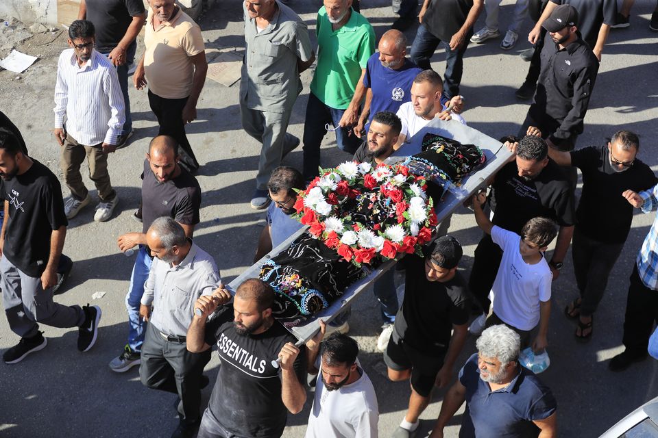 Relatives carry the body of a young girl, killed in an Israeli airstrike, during her funeral procession in the southern village of Saksakieh, Lebanon (Mohammed Zaatari/AP)