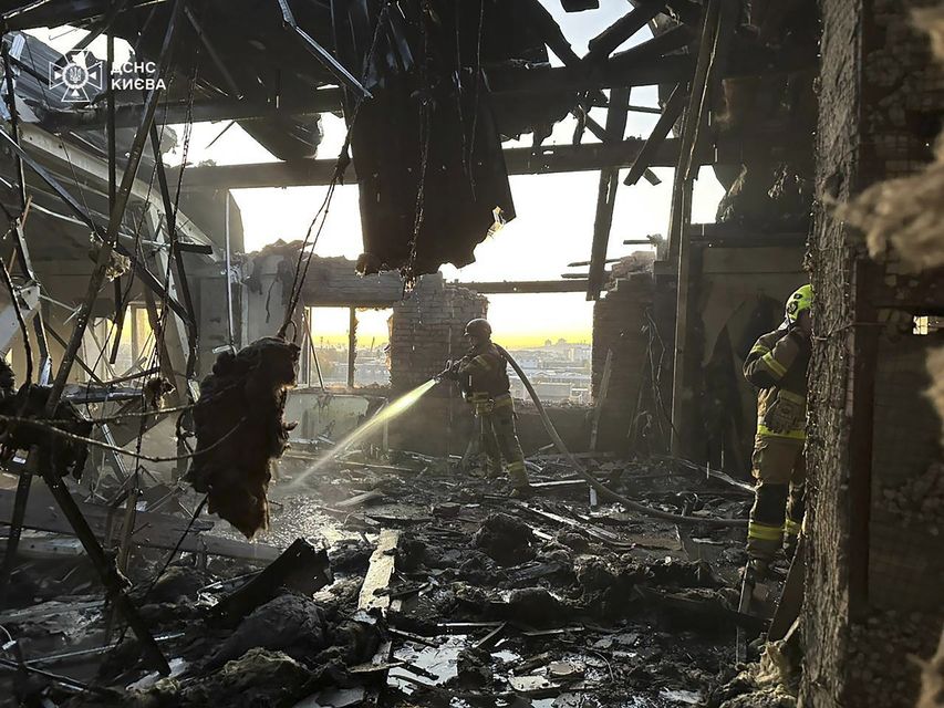 A rescuer puts out a fire resulting from a Russian drone attack in Kyiv, Ukraine (Ukrainian Emergency Service/AP)