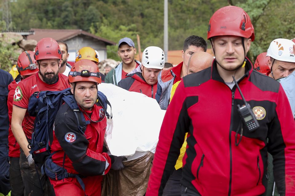 Members of the mountain rescue service carry the body of a victim of a landslide in Donja Jablanica in southern Bosnia (Armin Durgut/AP)