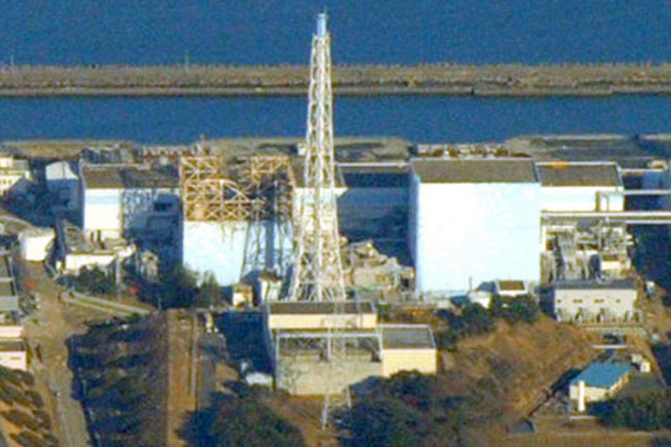 The No. 1 reactor of the Fukushima Daiichi Nuclear Power Plant, is seen at left, with its upper part of the walls blown off after an explosion in Okumamachi, Fukushima Prefecture (state), northeastern Japan, Saturday, March 12, 2011. (AP Photo/Mainichi Shimbun, Taichi Kaizuka) JAPAN OUT NO SALES ONLINE OUT MANDATORY CREDIT
