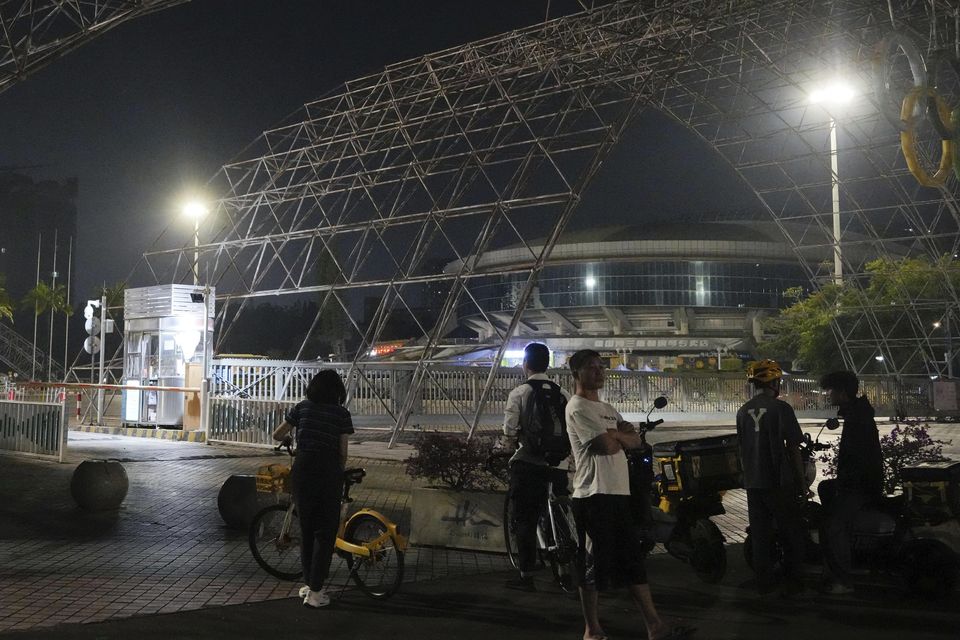 People gather near the sports centre after the incident (Kyodo News/AP)