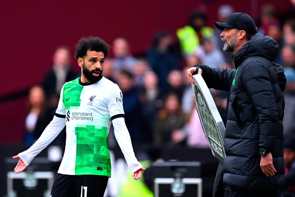 Liverpool's Mohamed Salah clashes with manager Jurgen Klopp before coming on as a substitute against West Ham