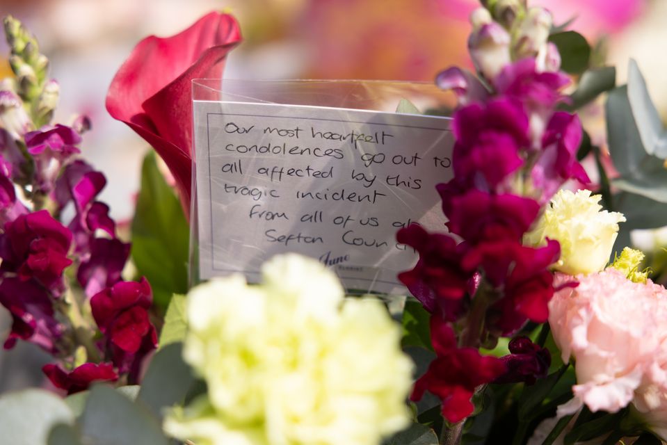 Messages and floral tributes near the scene in Hart Street, Southport (James Speakman/PA)