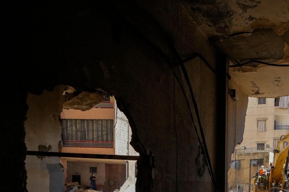 Emergency workers use excavators to clear the rubble at the site of Friday’s Israeli strike in Beirut’s southern suburbs, Lebanon (Hassan Ammar/AP)