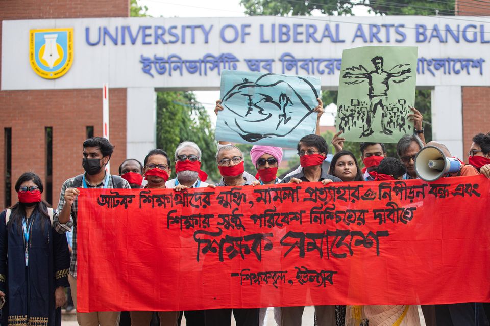 University teachers wear red masks as they demand justice for the victims killed in the recent countrywide deadly clashes during a protest in Dhaka, Bangladesh, on Wednesday (Rajib Dhar/AP)