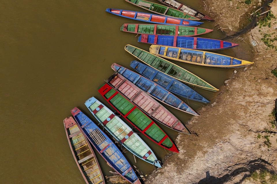 Boats sit on the bank of the Acre River (Marcos Vicentti/AP)