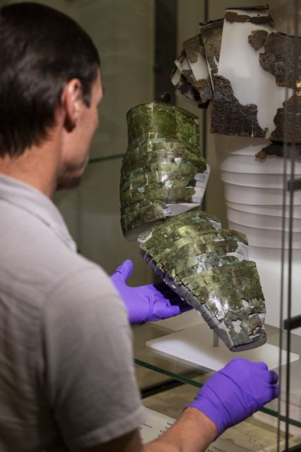 The arm guard, which was found in over 100 individual pieces, was in “remarkably” good condition, with the remnants of leather straps attached to some of the metal (Duncan McGlynn/PA)