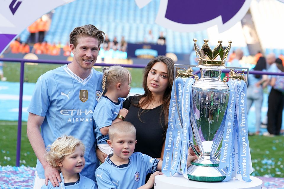 Kevin De Bruyne poses for a photo with wife Michele Lacroix, their children and the Premier League trophy (Martin Rickett/PA)