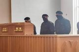 thumbnail: Masked men at a funeral at Roselawn crematorium