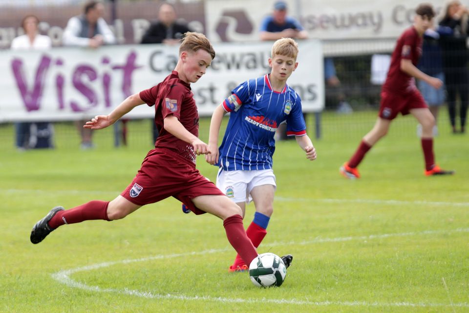 Linfield’s Calum Evans with Lucas Macleod of Ross County