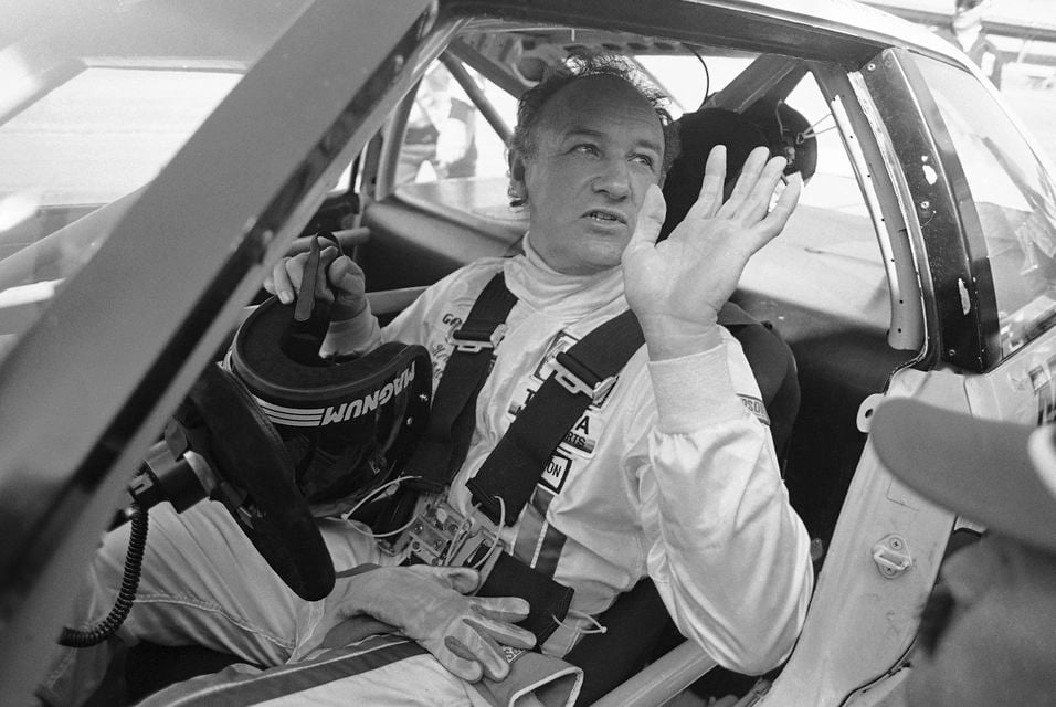 Gene Hackman waves as he starts out for a practice run in his Toyota Celica in 1983 (Bob Self/AP)