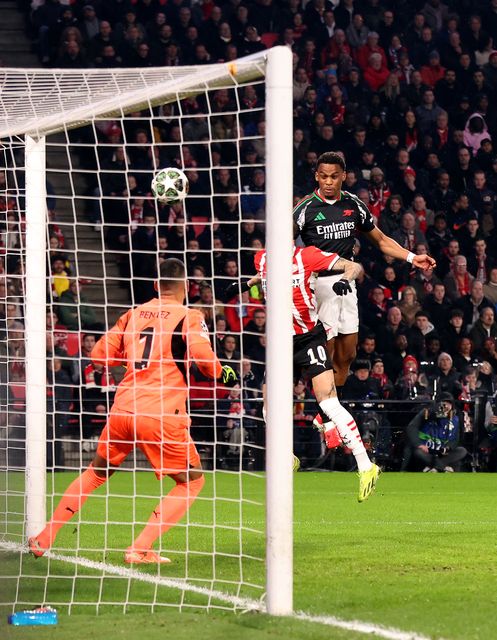 Jurrien Timber heads home Arsenal’s first goal against PSV Eindhoven (Peter Lous/PA)