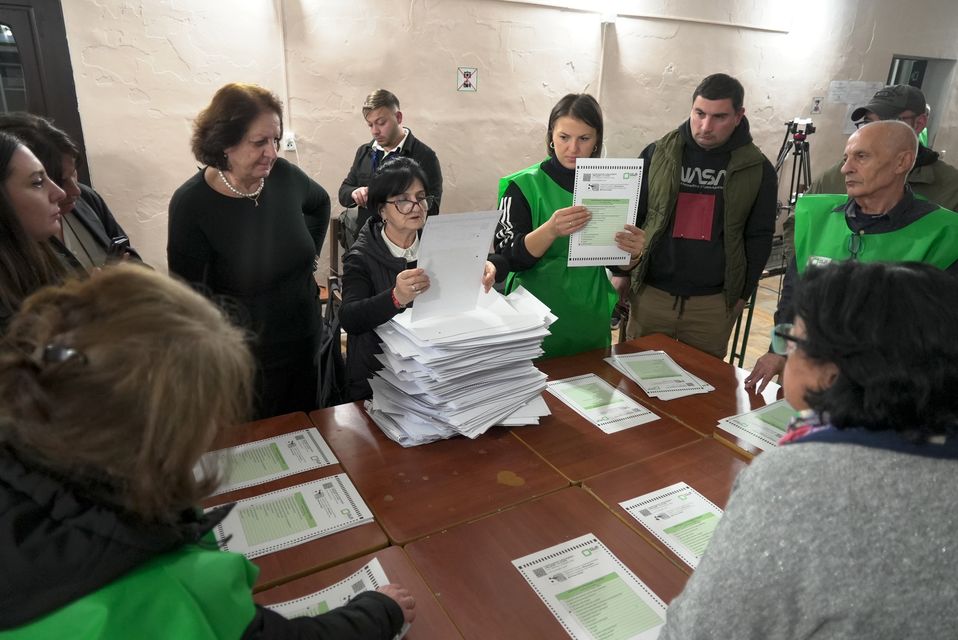 Members of an election commission count ballots at a polling station after the parliamentary election in Tbilisi, Georgia (Kostya Manenkov/AP)