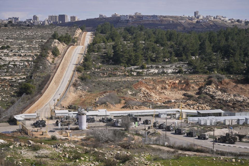 Military vehicles are lined up at the Israeli Ofer prison in the West Bank city of Beitunia awaiting the release of Palestinian prisoners (Nasser Nasser/AP)