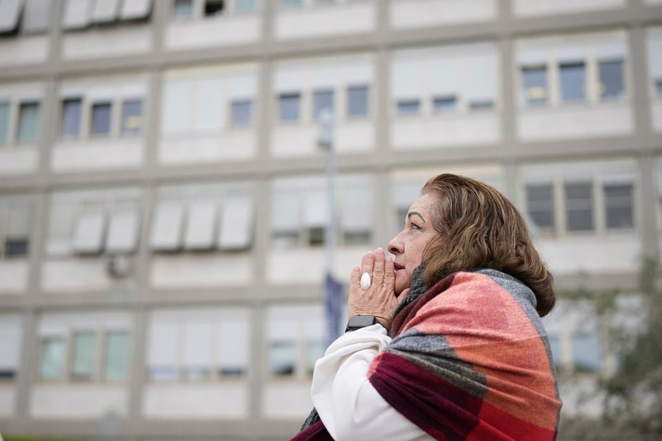 A woman prays outside the hospital in Rome where Pope Francis is being treated (Alessandra Tarantino/AP)