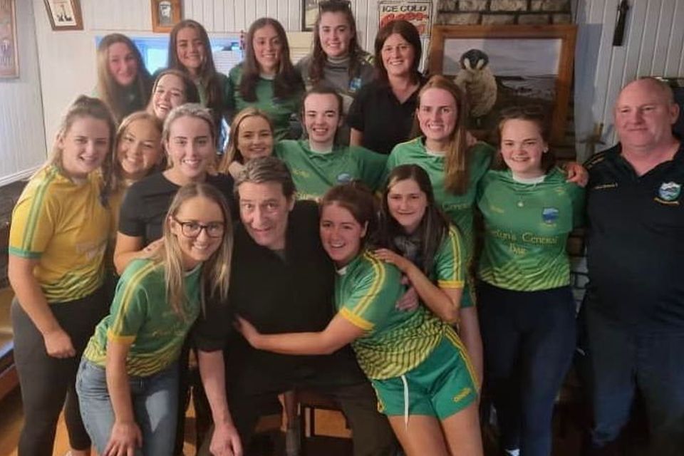 Ciaran Hinds  with members of the Naomh Columba  ladies’ team