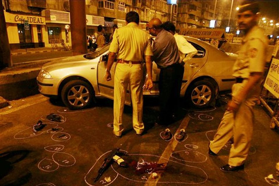 Police officers inspect a car after they shot dead two suspects in Mumbai, India, on late Wednesday night November 26, 2008. Teams of heavily armed gunmen stormed luxury hotels, a popular restaurant, hospitals and a crowded train station in coordinated attacks across India's financial capital Wednesday night, killing at least 78 people and taking Westerners hostage, police said. (AP Photo)
