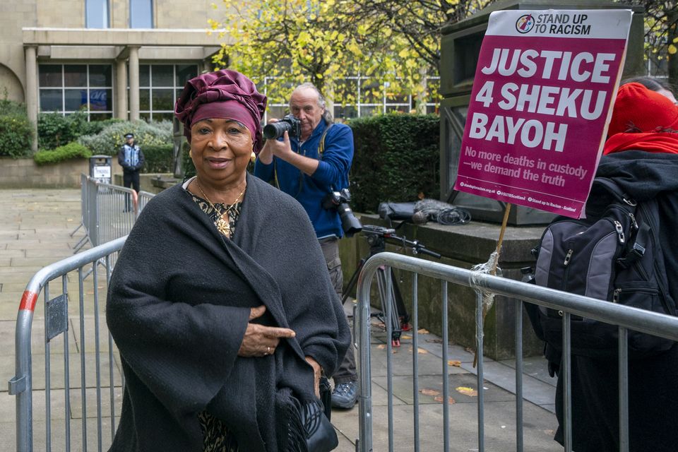 Skehu Bayoh’s mother Aminata with supporters outside a previous sitting of the inquiry into her son’s death (PA)