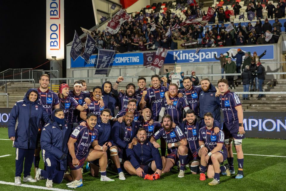 The Bordeaux Bègles squad celebrate with the travelling fans after their victory over Ulster