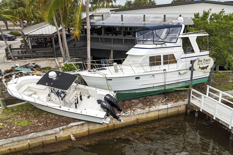 Boats rest beside a restaurant after being pushed up by floodwaters from Hurricane Helene in St Petersburg, Florida (AP Photo/Mike Carlson)