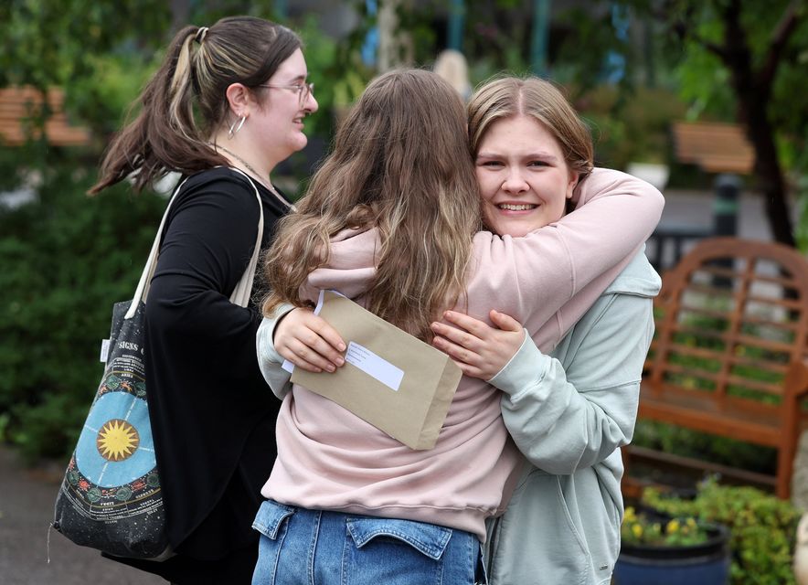 Niamh Davis Wilson (right), of Bloomfield Collegiate School in east Belfast, receives a hug from a friend after opening her AAB results. Picture by Jonathan Porter/PressEye