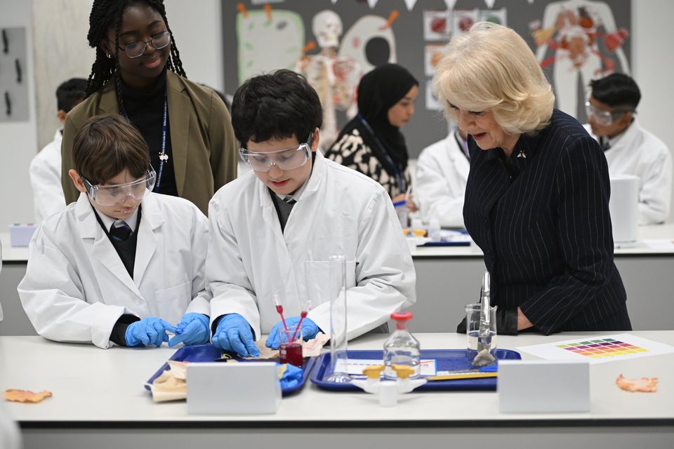 The Queen stopped off in the school’s science lab (Eddie Mulholland/The Telegraph/PA)